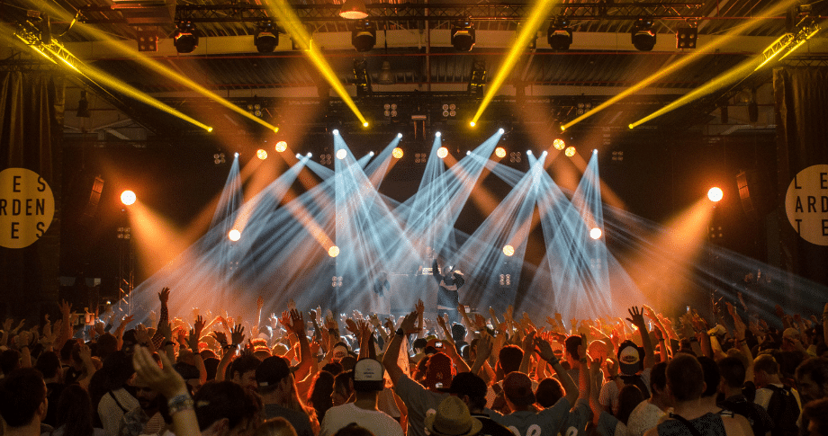 People in a crowd in front of a stage