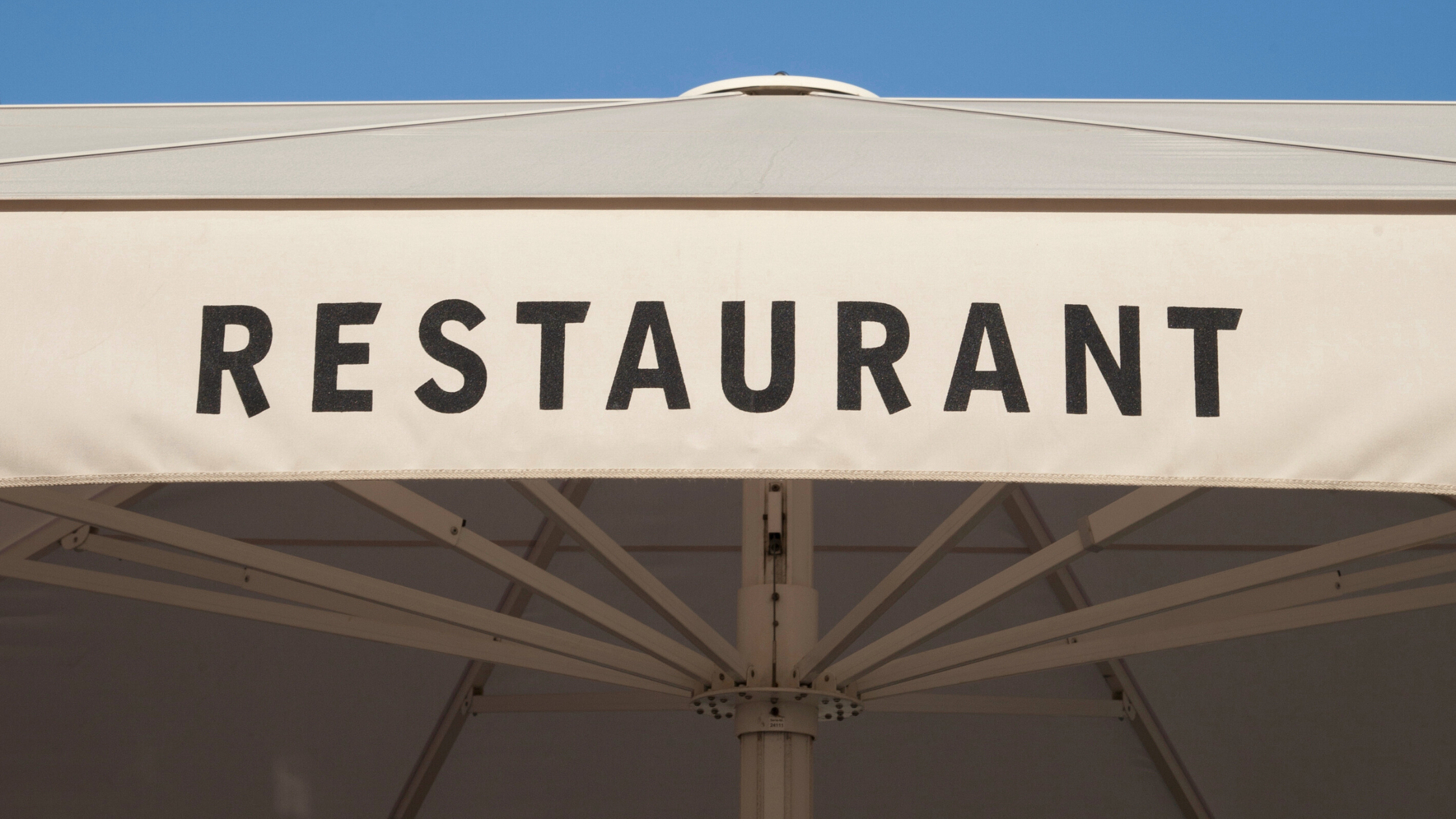 Black Restaurant branding on white fabric